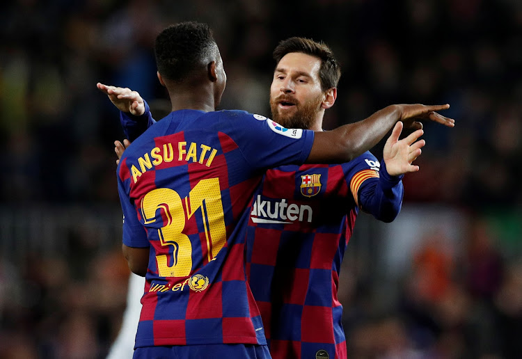 Barcelona's Anssumane Fati celebrates scoring their first goal with Lionel Messi