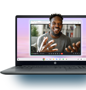 A man smiles during a Google Meet call that is displayed on an open Chromebook's screen.