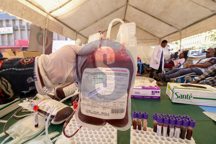 Lab technician Derrick Muiti press a Feder bag during the blood donation exercise during a blood drive exercise conducted by Kenya Red-Cross near National Archives Nairobi on Tuesday 28, 2022.