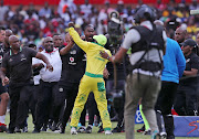 A Mamelodi Sundowns fan attacks Orlando Pirates' assistant coach Rulani Mokwena during an Absa Premiership encounter at Loftus Versfeld on Saturday November 10 2018. 
