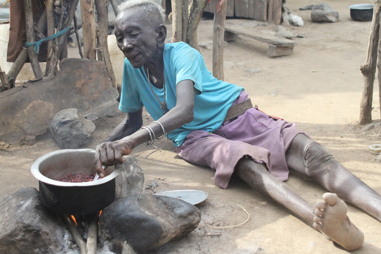 Emaciated 90-year-old Turkana granny Mary Naukot prepares beans and rice at Kampi Turnana in Marigat, Baringo South subcounty on March 10.