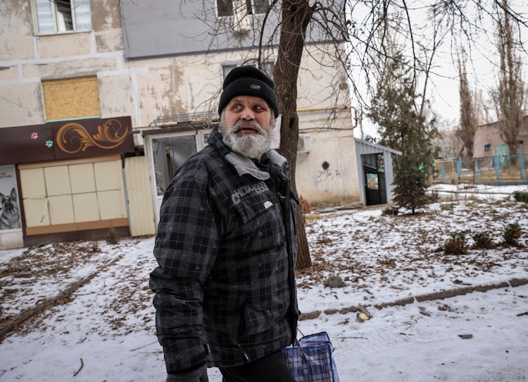 A resident reacts during a shelling as he walks through an empty street of Bakhmut, Ukraine, February 7 2023. Picture: YEVHEN TITOV/REUTERS