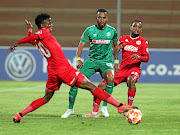 Highlands   player Sphiwe Mahlangu, left, tries to dribble past AmaZulu's Siyethemba  Sithebe  at Makhulong on Tuesday.  