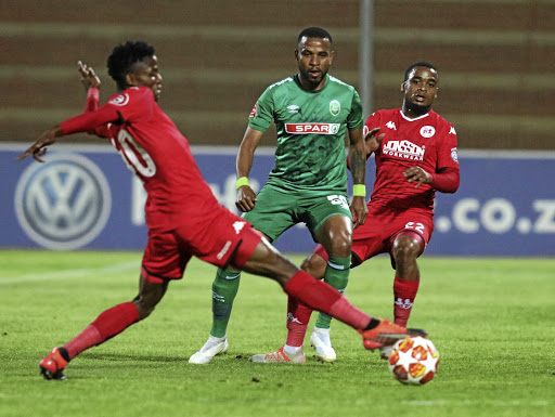 Highlands player Sphiwe Mahlangu, left, tries to dribble past AmaZulu's Siyethemba Sithebe at Makhulong on Tuesday.