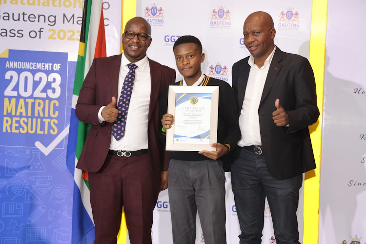 Gauteng MEC of education Matome Chiloane with Wandile Lungani Mkhwanazi who obtained a 100% pass in geography and physical science in the 2023 NSC exams.