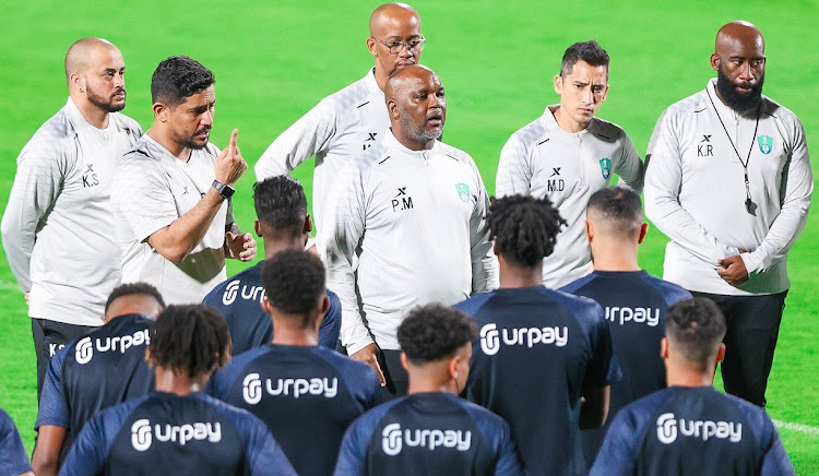 Al-Ahli Saudi FC coach Pitso Mosimane addresses his players and technical staff during a training session.