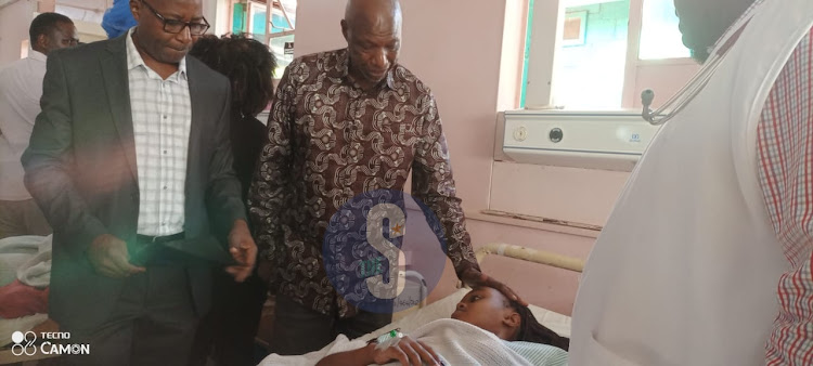 Kenyatta University Vice Chancellor Paul Wainaina comforting an injured student at the Moi County Referral Hospital ward in Voi, Taita Taveta on March 19, 2024.