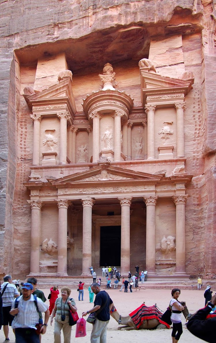 The Treasury (Al Khazneh) is half-built, half-carved into the rock in the deserts of Petra, Jordan.