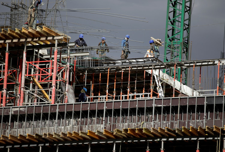 Workers are seen in a building undergoing construction. File photo: REUTERS/ANDRES MARTINEZ CASARES