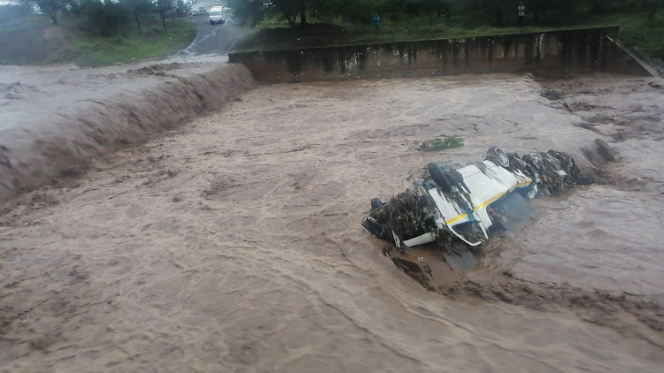 A taxi was swept into the flooded Duzi River on Wednesday. All four people on board survived.