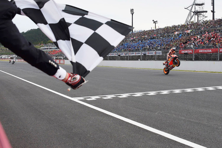 Marc Marquez of Spain and Repsol Honda Team cuts the finish lane and celebrates the victory at the end of the MotoGp race during the MotoGP of Japan - Race at Twin Ring Motegi on October 20, 2019 in Motegi, Japan.