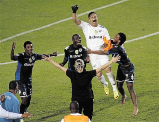 MISSED : Bidvest Wits goalkeeper Moeneeb Josephs celebrates with teammates Photo: Veli Nhlapo