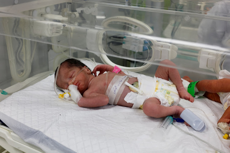 A Palestinian baby girl, saved from the womb of her mother Sabreen Al-Sheikh (Al-Sakani), who was killed in an Israeli strike along with her husband Shokri and her daughter Malak, lies in an incubator at Al-Emirati hospital in Rafah in the southern Gaza Strip, on April 21 2024.