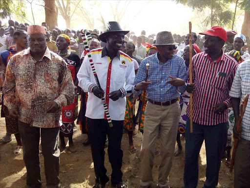 Kapenguria mp Samuel Moroto, Turkanan south mp James Lomenen, IG Joseph Boinnet, west pokot senator John Lonyangapuo, sigor mp Philip Rotino and Kacheliba MP mark Lomunokol Join traditional dancers in a jig