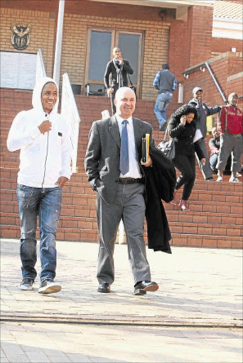 A WHOLE NEW BALL GAME: Bafana captain Steven Pienaar with his lawyer, Cliff Alexander, outside the Randburg Magistrate's Court. PHOTO: ANTONIO MUCHAVE