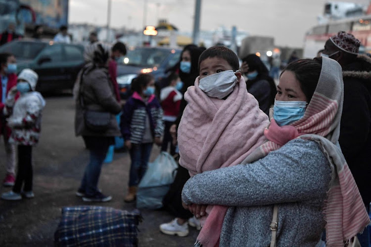 Migrants transferred from the Moria camp on the island of Lesbos disembark in Piraeus near Athens earlier this month. Greece will extend to May 21 a coronavirus lockdown imposed on migrant camps. It was expected to be lifted from May 11 but authorities did not explain the extension.