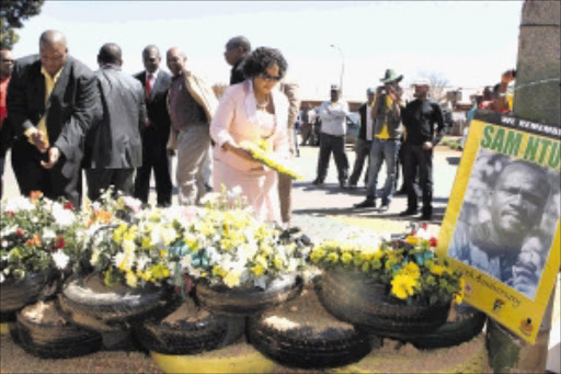 LEST WE FORGET: Gauteng Premier Nomvula Mokonyane lays wreaths yesterday for the Thokoza victims of violence, including unionist Sam Ntuli. PHOTO: MOHAU MOFOKENG