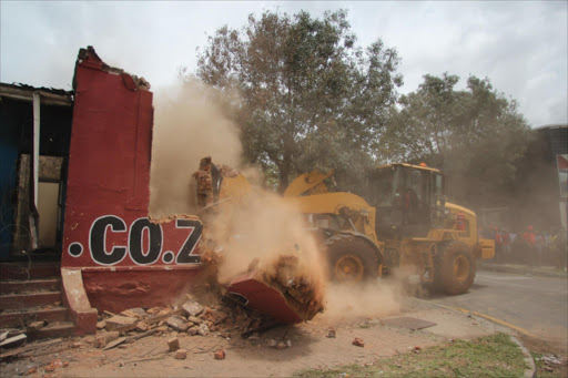 A dilapidated building was demolished outside Mogale City today. Picture: Nico Gous