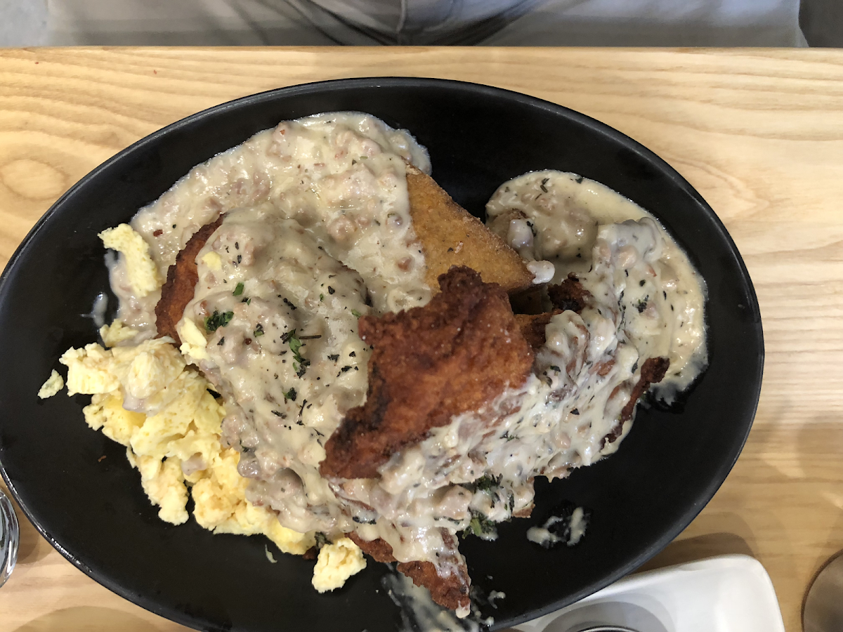 Grits and gravy, with added eggs and fried chicken.