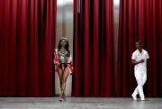 Master of ceremony Fabian Joseph  admires as Lezy Shinga,18, from Umlazi as she showcase herself in a swimwear at a pageant in Newslands East Community Hall. 