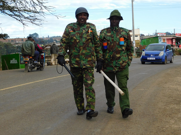 Armed police officers patrol Ol Kalou streets on Wednesday