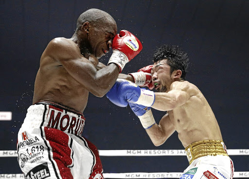 IBF flyweight champ Moruti Mthalane punches Akira Yaegashi of Japan in December. / Kyodo News/ Getty Images