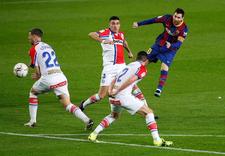 Barcelona's Lionel Messi shoots for goal in their match against Alaves