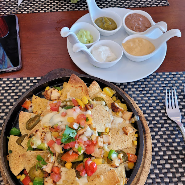 The nacho plate with sauces on the side