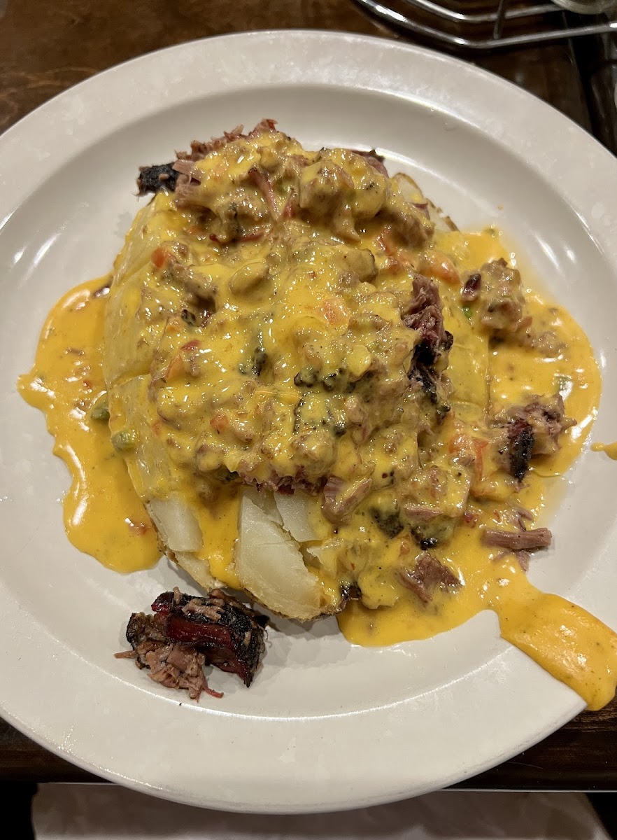 Baked potato smothered in brisket & queso