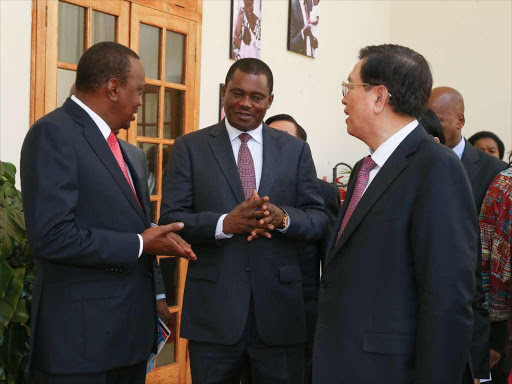 President Uhuru Kenyatta, Zhang Dejiang, the Chairman of the Standing Committee of the National People's Congress of China and Speaker of the National Assembly, Justin Muturi, converse after bilateral talks between Kenya and China at State House, Nairobi.