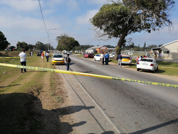 POLICE INVESTIGATING: Victoria Drive is cordoned off after a 60-year-old metro traffic officer was shot dead this morning in Walmer township