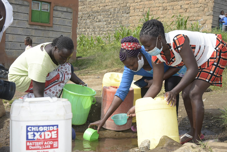 Nyacaba Village residents draw water from a well on Monday.
