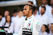 Lewis Hamilton of Great Britain and Mercedes GP is seen at the Mercedes GP team photo in the Pitlane during previews ahead of the F1 Grand Prix of Abu Dhabi at Yas Marina Circuit on November 28, 2019 in Abu Dhabi, United Arab Emirates