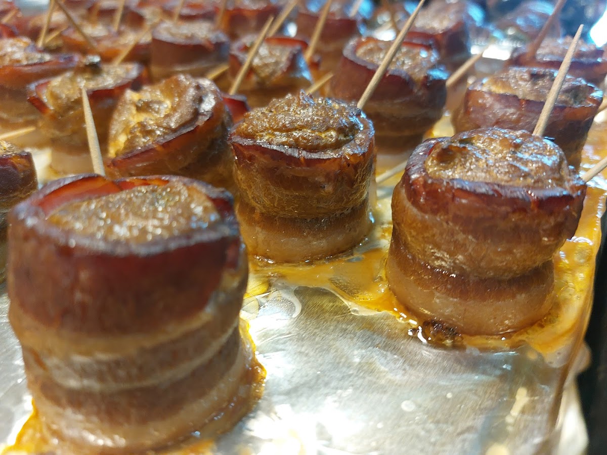 Pig Shots - we build a "shot glass" with a slice of andouille sausage as the base and thick bacon as the walls. Then we fill it with a mixture of cheeses and diced jalapeño.  Then we smoke it!  And we finish them off in the oven with a brush off barbeque sauce and sprinkle of black pepper.