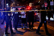 Police officers detain a man as they enforce an 8pm curfew imposed by local authorities on spring break festivities, amid the coronavirus disease (Covid-19) pandemic, in Miami Beach, Florida, U.S., March 20, 2021. 