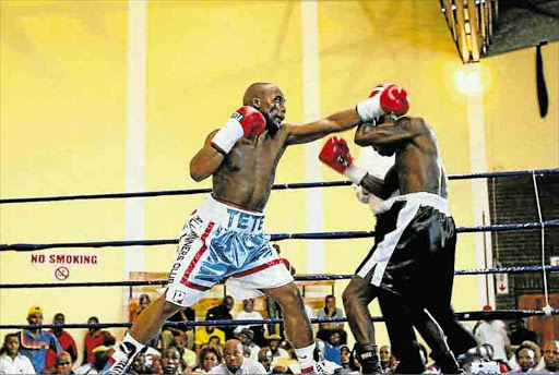 OUT OF REACH: Makazole Tete swings a left to the head in the WBA Pan-African flyweight title fight against Doctor Ntsele at the Orient Theatre Picture: SINO MAJANGAZA