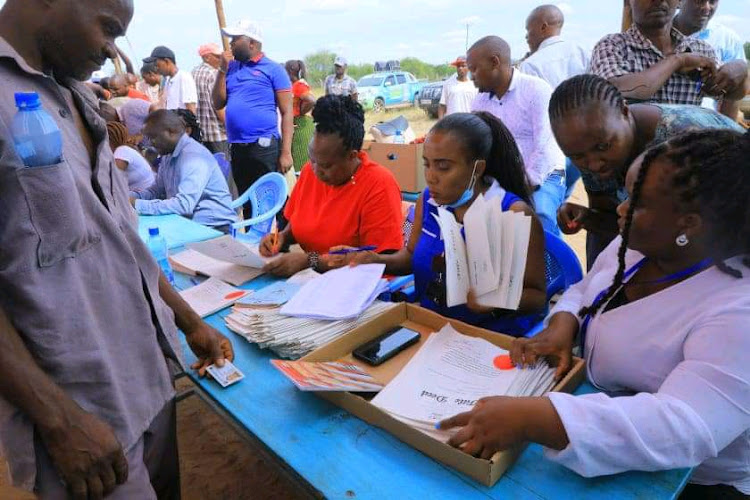 Nzalae residents in Mwingi West, Kitui receiving title deeds for their land on Monday, April, 11.