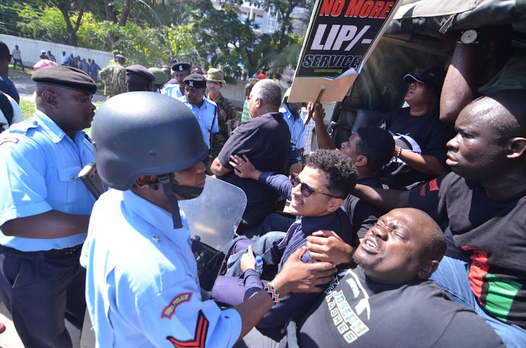 Activists being arrested on Monday outside the City Blue Hotel near the Nyali Bridge on Monday, October 7, 2019.