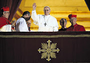 Newly elected Pope Francis I waves to the waiting crowd from the central balcony of St Peter's Basilica in Vatican City last night. Argentinian Cardinal Jorge Mario Bergoglio is the 266th pontiff to lead the world's 1.2 billion Catholics