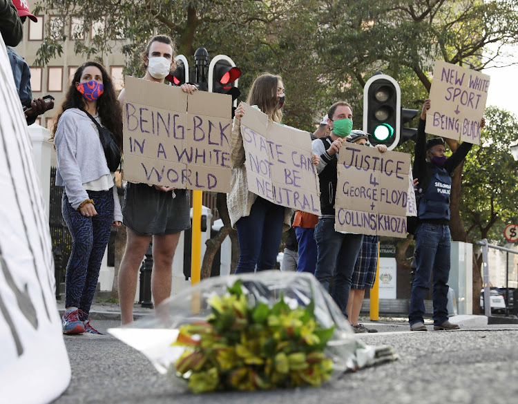 Activists protest outside parliament in Cape Town on Wednesday over the murder of American George Floyd.