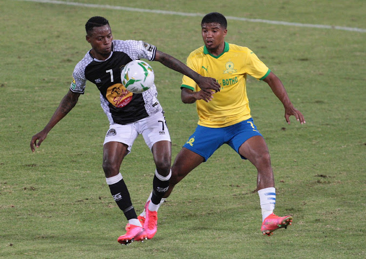 Lyle Lakay of Sundowns and Phillippes Kinzumbu of Mazembe during the CAF Champions League match between Mamelodi Sundowns and TP Mazembe at Loftus Versfeld Stadium.