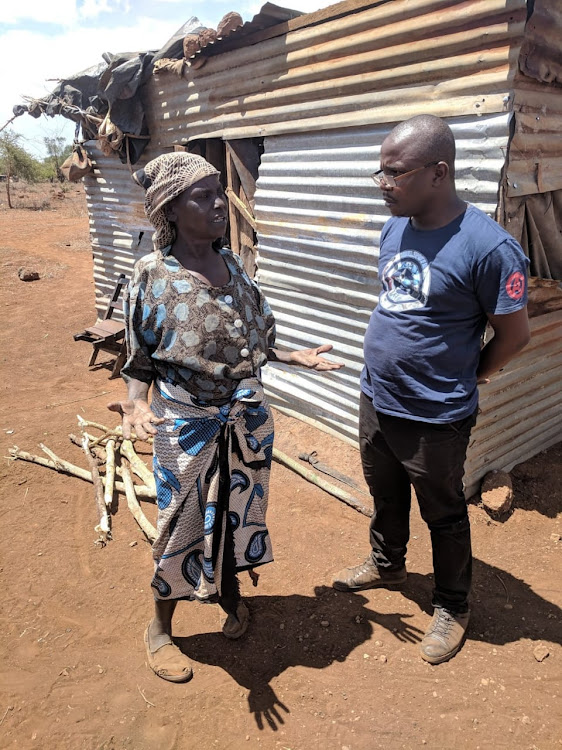 Haki Yetu's Justus Wanyama talks to Mary Msegha at Njukini area of Taita Taveta county last Friday.