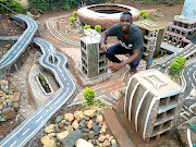 Mulalo Negondeni of  Mukula village in Venda uses soil, sand, cement and   recyclable waste materials  to design his creations, like the FNB Stadium in the background.  