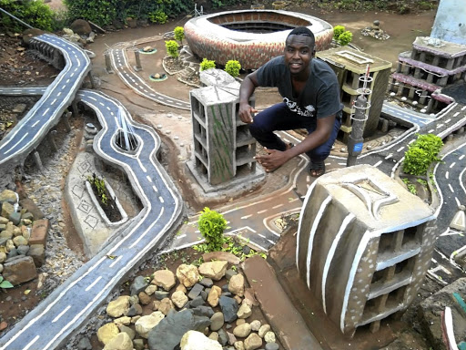 Mulalo Negondeni of Mukula village in Venda uses soil, sand, cement and recyclable waste materials to design his creations, like the FNB Stadium in the background.