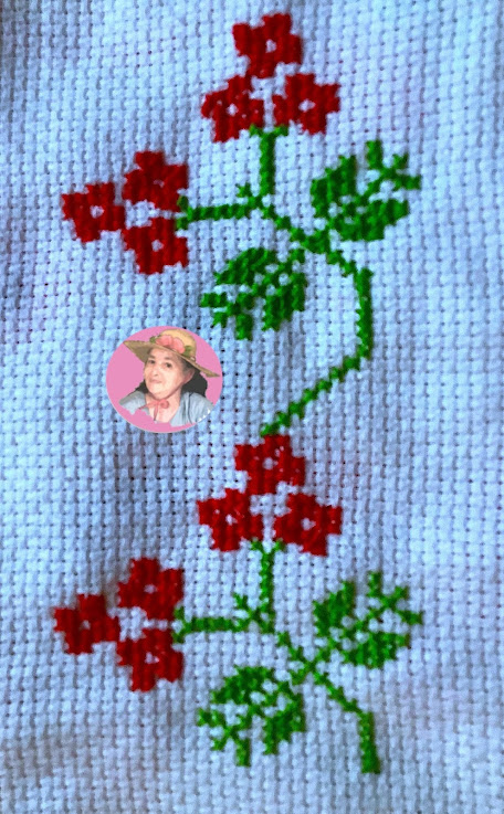 Flowers in a vine made in cross stitch 