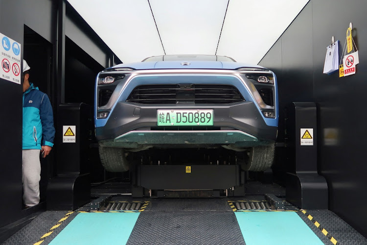 A Nio ES8 electric SUV changing its battery is seen inside a power station at a JAC Motors-NIO plant in Hefei, Anhui province, China. File photo: REUTERS/SUN YILEI