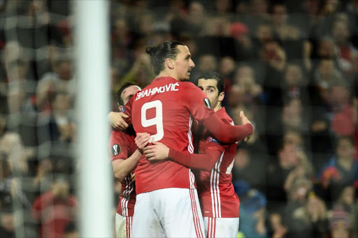 (L-R) Manchester United's Spanish midfielder Juan Mata, Manchester United's Swedish striker Zlatan Ibrahimovic and Manchester United's Armenian midfielder Henrikh Mkhitaryan (R) celebrate after Mata scored the opening goal during the UEFA Europa League round of 16 second-leg football match between Manchester United and FC Rostov at Old Trafford stadium in Manchester, north-west England, on March 16, 2017.