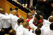 Security officials remove members of the Economic Freedom Fighters during President Jacob Zuma's State of the Nation Address (SONA) to a joint sitting of the National Assembly and the National Council of Provinces in Cape Town, South Africa. Picture Credit: REUTERS/Sumaya Hisham