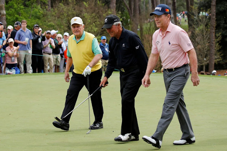 Golf greats Jack Nicklaus, Gary Player (centre) and Tom Watson (right) walk off the first hole during the par three contest held on the final day of practice for the 2018 Masters golf tournament at Augusta National Golf Club in Augusta, Georgia, US April 4, 2018