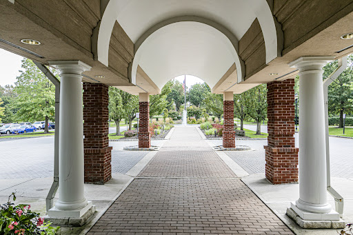 Paved walkway under arch with columns in this luxury apartment / penthouse for sale in Princeton ($550,000)